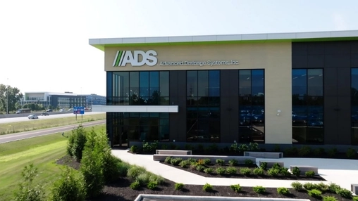 Advanced Drainage Systems building with company signage, glass windows, and landscaped grounds
